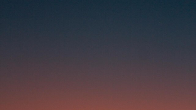 Fiery sunset with crescent moon Crescent moon and fiery orange sunset horizon