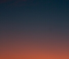 Fiery sunset with crescent moon Crescent moon and fiery orange sunset horizon